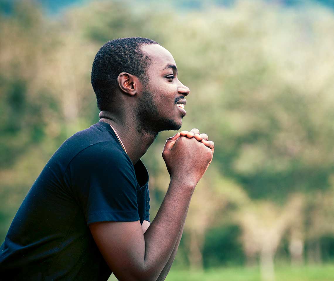 Joyful young man praying